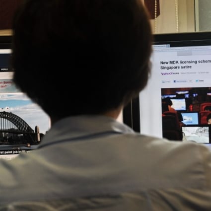 A person browses through media websites on a computer in Singapore. Photo: AFP
