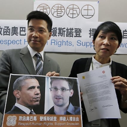 Two pan-democratic lawmakers Gary Fan Kwok-wai and Claudia Mo Man-ching show  the letter that they sent to US President Barack Obama on Friday. Photo: AP