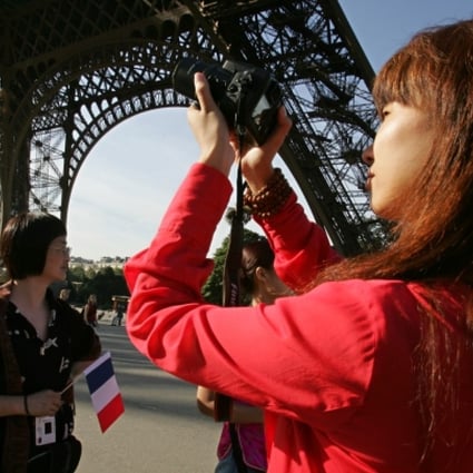 Chinese tourists visit the Eiffel Tower in Paris. Photo: AFP