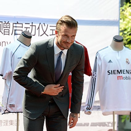 David Beckham is on his second Beijing visit in three months. His jerseys were part of a fund-raising auction for youth soccer in China. Photo: Xinhua