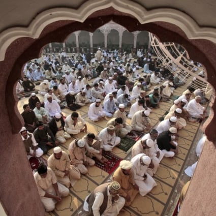 Pakistani men attend prayers in a Mosque in Peshwar, Pakistan. Photo: AP