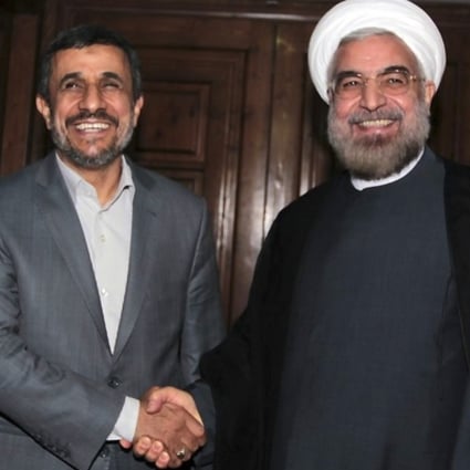 Outgoing Iranian President Mahmoud Ahmadinejad (left) shakes hands with President elect Hasan Rowhani. Photo: AP
