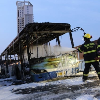 Firefighters try to extinguish the fire on a bus in Xiamen, southeast China's Fujian Province. Photo: Xinhua