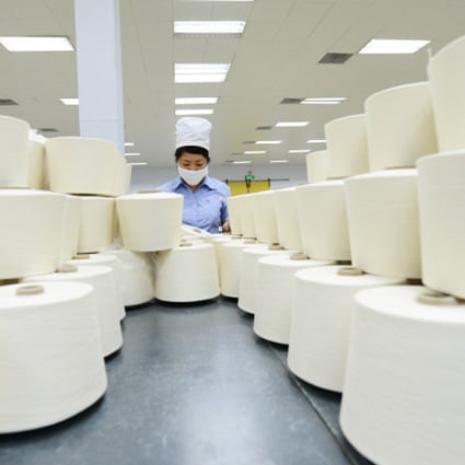 A worker works at a textile factory in Shandong. Photo: Xinhua