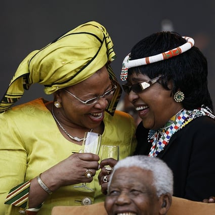 Graca Machel (left), Nelson Mandela and ex-wife Winnie Madikizela-Mandela share a laugh at his 90th birthday party in 2008.Photo: AFP