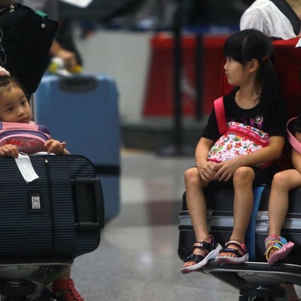 Children stranded at the Beijing Capital International Airport after their flights were cancelled due to heavy rain. Beijing and Shanghai rank at the bottom of 35 major international airports for flight delays and cancellations in a recent survey. Photo: AP