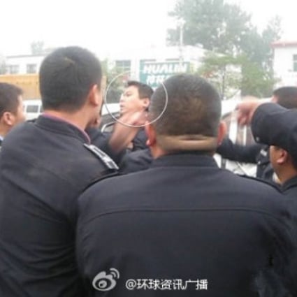 Bystanders documented the Qinghai policeman's beating by chengguan on Tuesday. Screenshot from Sina Weibo. 