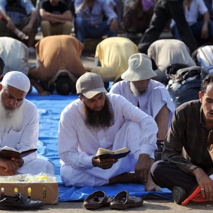 Egyptian supporters of deposed president Mohamed Morsi read the Koran, Islam's holy book, and pray, as they continue to hold a sit in outside Cairo's Rabaa al-Adawiya mosque. Egypt was braced for more bloodshed on Friday. Photo: AFP