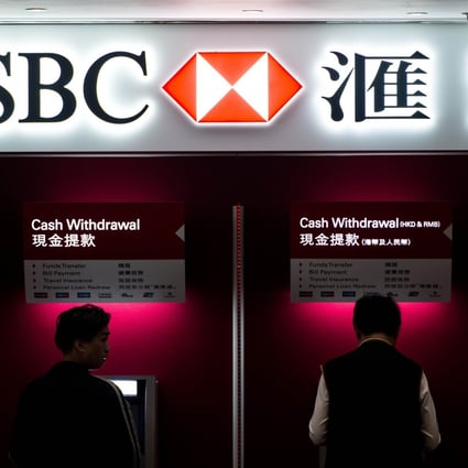 Two men use ATM machines at an HSBC branch in Hong Kong. Photo: ATM