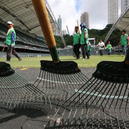 Ground staff work on the pitch at the Hong Kong Stadium ahead of tonight's clash between Manchester United and Kitchee. Photo: Felix Wong