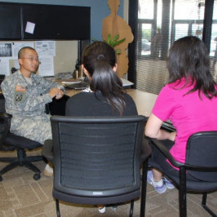 A military recruiter meets two Chinese women. Photo: Screenshot via World Journal