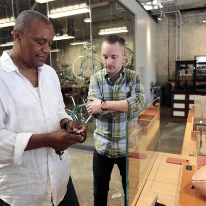 A Shinola employee (right) helps a customer with a Shinola watch. Small companies like Shinola are helping to revive the ‘Made in Detroit’ brand. Photo: Reuters
