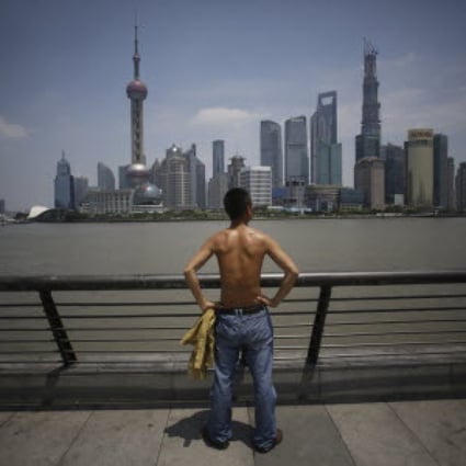 A Shanghai citizen strips his shirt off as temperatures in the city continue soaring. Photo: AP