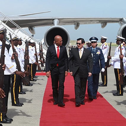 Taiwan's President Ma Ying-jeou (centre) arrives in Port-au-Prince and is welcomed by his Haitian counterpart Michel Martelly. Photo: EPA