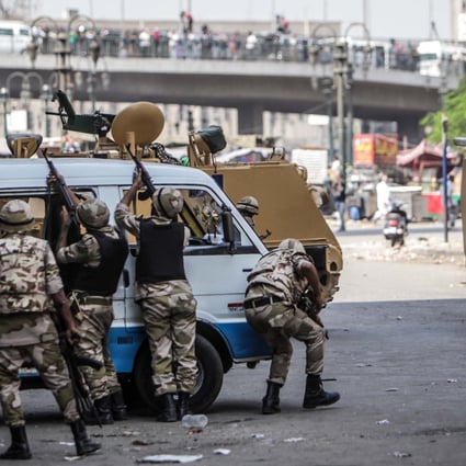 Soldiers firing during clashes in Ramses Square, Cairo. Photo: Xinhua