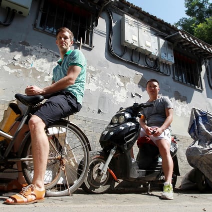 Swede Jojje Olsson (left) and native Beijinger Hou Lei in a hutong. The pair are collaborating on book they hope will help save these remnants of the old city. Photo: Simon Song