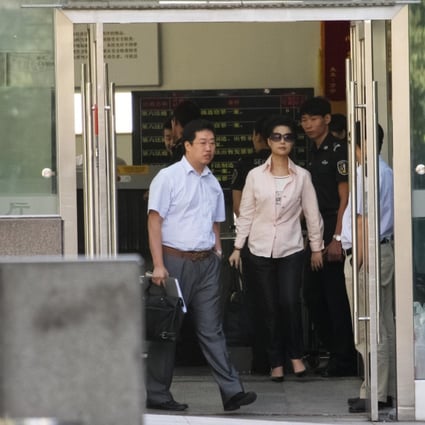 Defendant Li Guanfeng's mother, Meng Ge, leaves court in Beijing's Haidian district yesterday. Photo: CNS