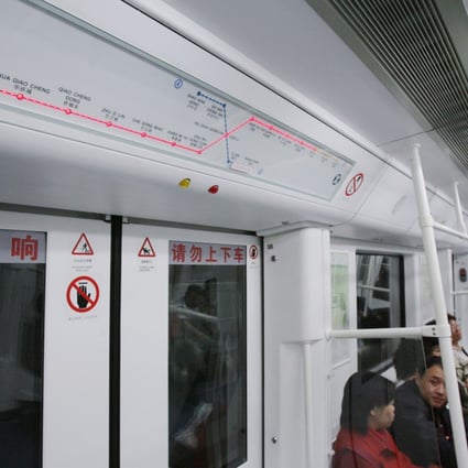 A woman was squeezed out from a Shenzhen metro carriage after doors opened suddenly. Photo: Edward Wong 