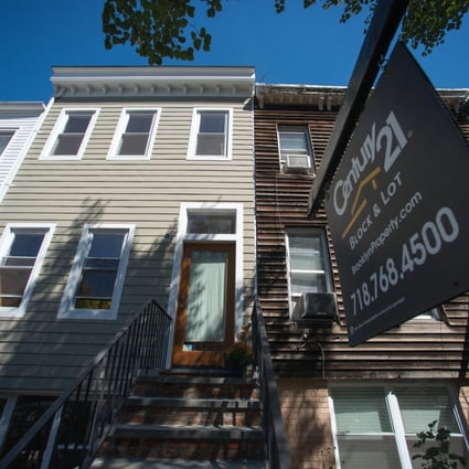 A "For Sale" sign outside a home in Brooklyn, New York, where buying is still more than 20 per cent cheaper than renting. Photo: Bloomberg