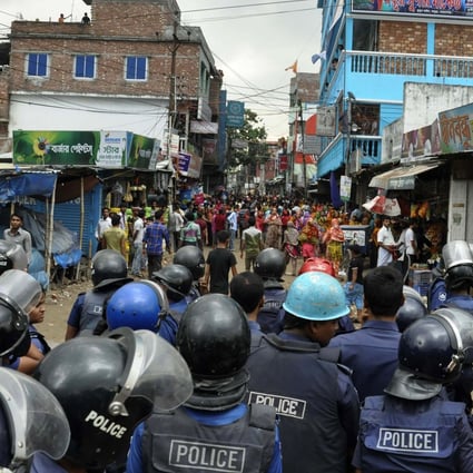 Bangladeshi police confront protesting garments workers on Wednesday. Photo: AFP