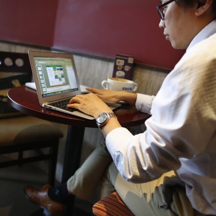 A man works on his computer inside a coffee shop in downtown Shanghai. Government employees monitor public opinion on social media. Photo: Reuters