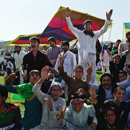 Afghan cricket fans celebrate runs by their team. Photo: AFP