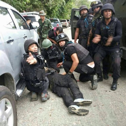 Thai police forces calling for first aid for colleague wounded during gun battle in Narathiwat province, southern Thailand. Photo: EPA