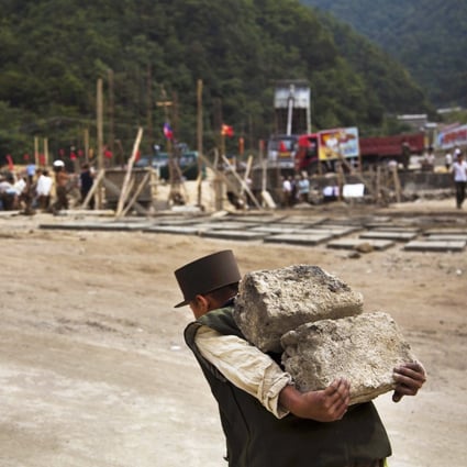 A North Korean construction worker carries bricks at a building project to construct a ski resort at North Korea's Masik Pass. Photo: AP