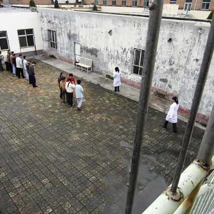 Patients stand at a yard inside a hospital which houses and provides treatment to about 40 patients who are suffering from mental illnesses, in Changzhi, Shanxi. Photo: Reuters