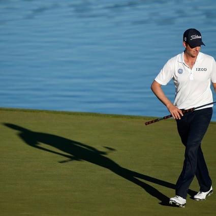 Webb Simpson examined his putter on the 16th green during the third round of the Shriners Hospitals for Children Open in Las Vegas. Photo: AFP