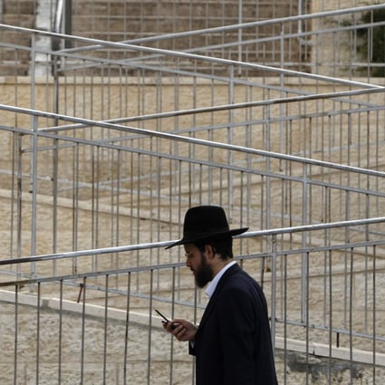 An ultra-Orthodox Jew holds walks through Ramat Shlomo, a  settlement in the occupied West Bank. Photo: Reuters