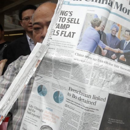 Tsang Kin-shing tears down a copy of South China Morning Post during a protest over the alleged self-censorship on the coverage of the death of mainland activist Li Wangyang in June last year.