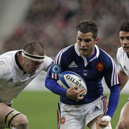 France's Brice Dulin runs with the ball as the All Blacks Brodie Retallikck and Dan Carter try to stop him at the Stade de France stadium in Saint Denis, outside Paris, on Saturday. Photo: AP