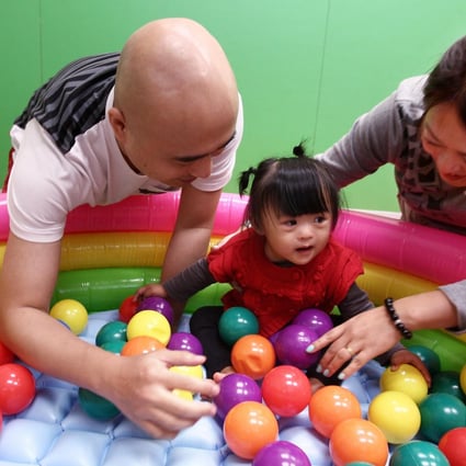 Venus Cheng, with mum Rebecca and dad Friend, plays at the Hong Kong Down Syndrome Association in Kowloon City. Photo: Jonathan Wong