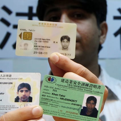 A Hong Kong born Pakistani man displays his identity cards. Ethnic minorities complain of racial profiling by police.