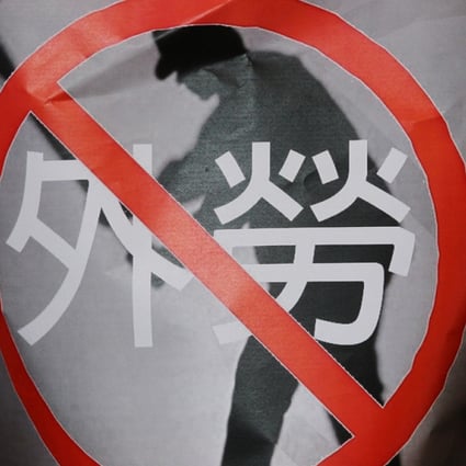 A protester's poster says no to foreign labour. Photo: K. Y. Cheng
