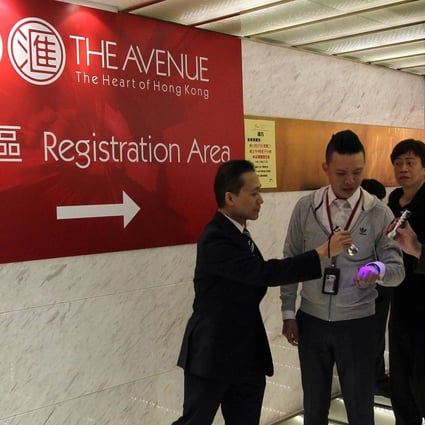 Potential buyers wait at Hopewell Centre for a chance to snap up units of Sino Land and Hopewell's The Avenue in Wan Chai. Photo: Sam Tsang