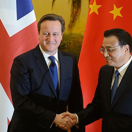 Britain's Prime Minister David Cameron and China's Premier Li Keqiang shake hands at a signing ceremony at the Great Hall of the People in Beijing. Photo: EPA
