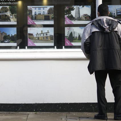 A potential London buyer looks at homes for sale. Photo: Bloomberg