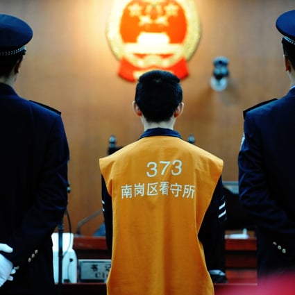 A defendant on trial at the Intermediate People's Court of Harbin, Heilongjiang Province. Courts in Henan province want to abolish the protocol of forcing defendants to wear prison suits and have their heads shaved. Photo: Xinhua 