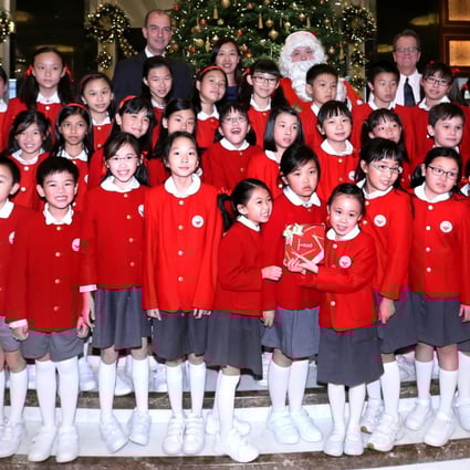 Children from the Singapore International School perform Christmas carols at the Kowloon Shangri-La Christmas tree lighting ceremony on Wednesday.  Photo: K. Y. Cheng