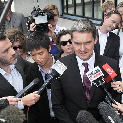 Rodney Croome (centre), director for Marriage Equality Australia talks to the media in front of the High Court of Australia in Canberra on Thursday. Photo: AFP
