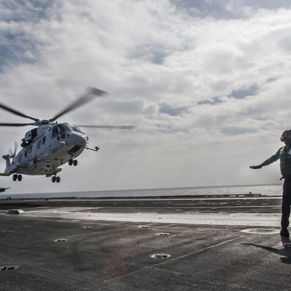 A helicopter of the Japan Maritime Self-Defence Force lifts off. Photo: Reuters
