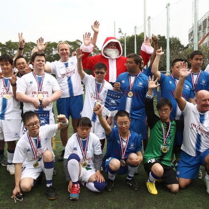 Players and coaches of the Hong Kong Football Club Crusaders at the tournament with their number one fan. Photo: Jonathan Wong