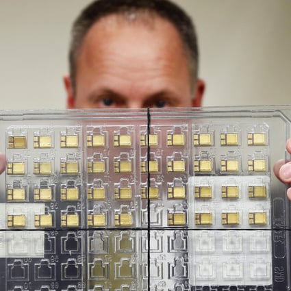 U.S. government's chief law enforcement officer displays a set of confiscated American-made radiation-hardened microchips, which were seized from a Chinese national who tried to smuggle them to China. Photo: Reuters