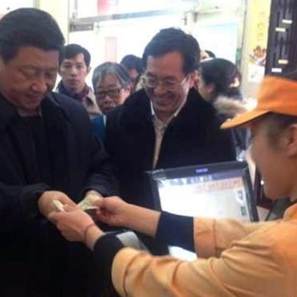 President Xi Jinping visits a Beijing pork-buns shop yesterday, paying 21 yuan for traditional northern dishes. Photo: SMP
