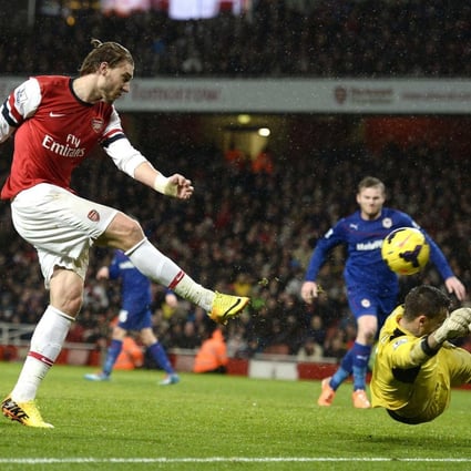 Arsenal's Nicklas Bendtner scores past Cardiff keeper David Marshall during their Premier League match at the Emirates. Photo: Reuters