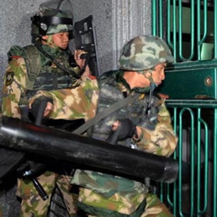 Police pictured during the raid in Boshe village, Lufeng city, Guangdong. Photo: SCMP/Handout