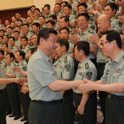 President Xi Jinping shakes hands with a military cadre during a tour of the Beijing Military Area Command. Photo: Xinhua