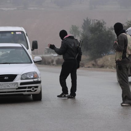 Free Syrian Army fighters man a checkpoint in Idlib to search for ISIL members. Photo: Reuters